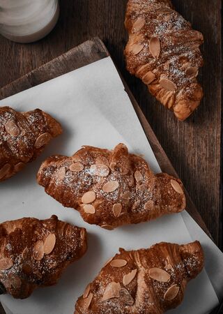 Almond croissant with custard filling on wood background.の写真素材