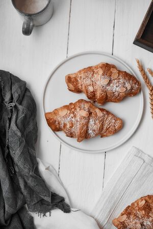Almond croissant with custard filling on wood background.の写真素材