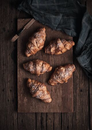 Almond croissant with custard filling on wood background.の写真素材