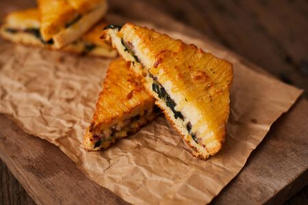 Baked spinach and ham sandwich with sauce.の写真素材