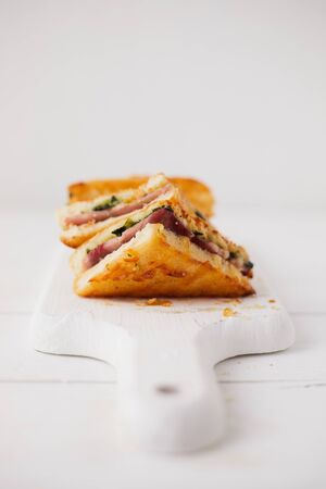 Baked spinach and ham sandwich with sauce.の写真素材