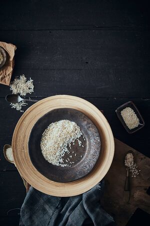 Rice of different varieties on wooden background.の写真素材