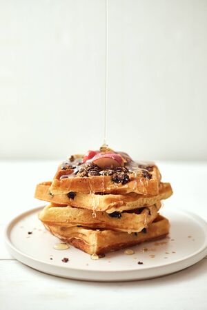 Homemade waffles with fruit and granola.の写真素材