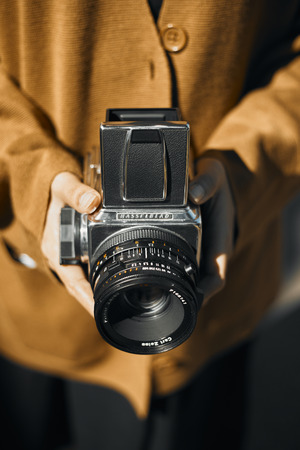 Chiang Mai, Thailand - December 10, 2019 : Vintage young hipster girl photographer hand holding retro camera.のeditorial素材