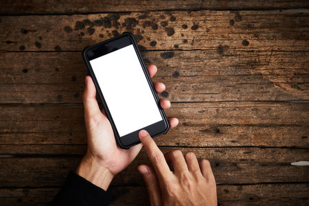 Smartphone white screen on wooden table.Top view