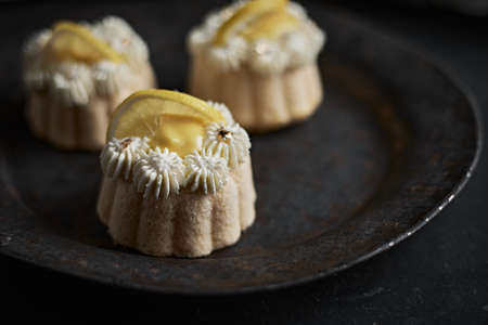 mini lemon bundt cakes topped with lemonの写真素材