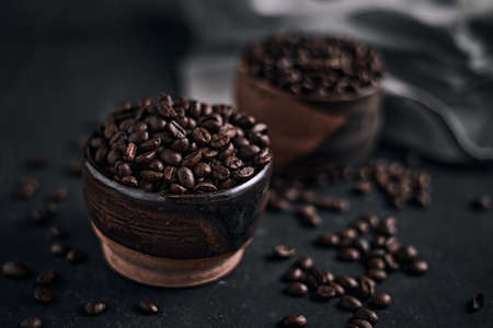 Coffee cup with roasted beans on dark background.の写真素材