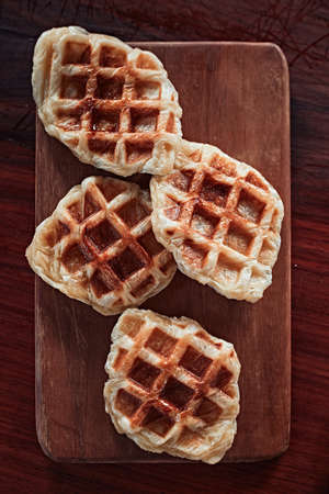 Homemade Croissant Waffle (Croffle) on wood background.の写真素材