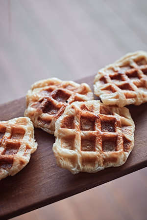 Homemade Croissant Waffle (Croffle) on wood background.の写真素材
