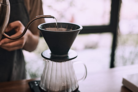 Hand drip coffee, Barista pouring water on coffee ground with filter