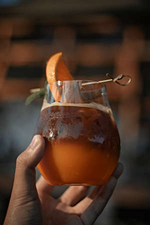 A glass of iced americano black coffee and layer of orangeの写真素材