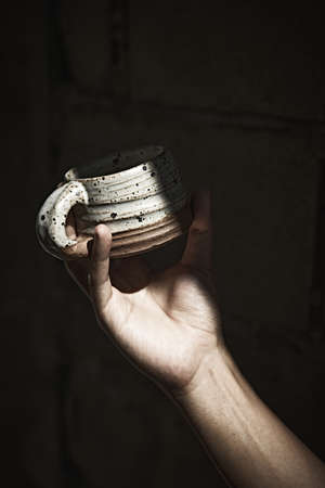 Hand holding a cup of coffee on blur background.の写真素材