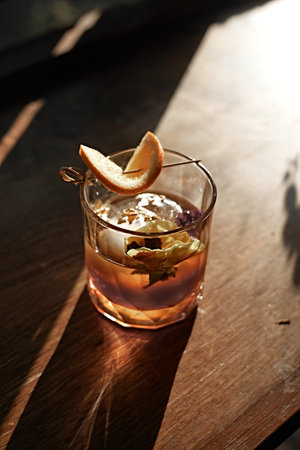 A close up shot of a glass cocktail with fine luxury whisky.