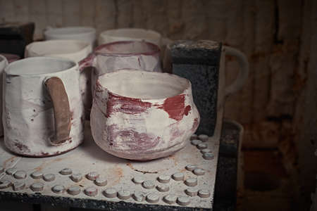 clay mugs in kiln for firing pottery in pottery studio.の写真素材