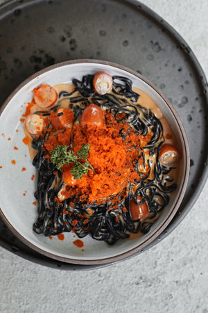 Black spaghetti cream sauce with ebikoの写真素材