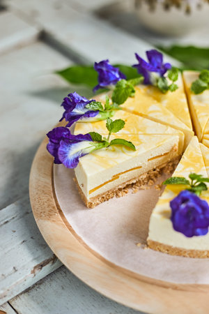 mango cheese cake on wood background,selective focus