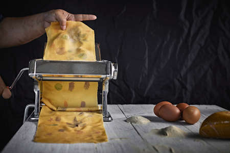 Cropped Hand Of Man Preparing Pasta.の写真素材