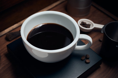 Coffee cup and beans on the wooden table