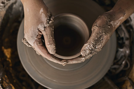 Hands of craftsman artist working on pottery wheel.Selective Focusの写真素材