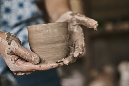 Hands of craftsman artist working on pottery wheel.Selective Focusの写真素材