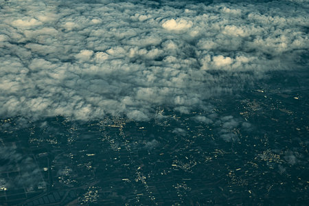 Aerial view of cityscape under cloudsÂ from the airplane