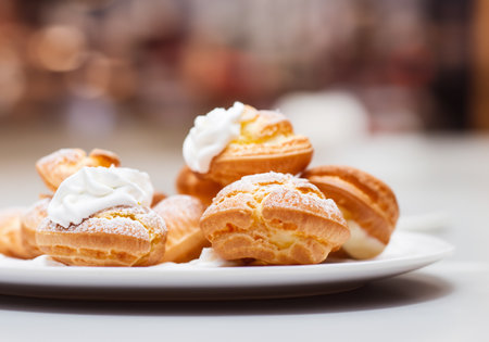 Profiterole with whipped cream and icing sugarの素材