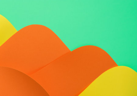 Orange and yellow sheets of paper on green backgroundの素材