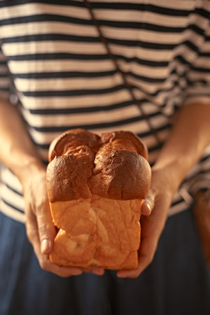 Female hands holding homemade fresh bread, Bakery products.