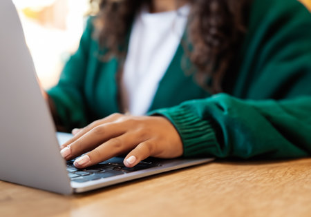 Close up Young woman using laptop at table in cafeÂ の素材