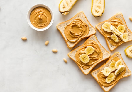 Overhead view of peanut butter and banana toastÂ の素材