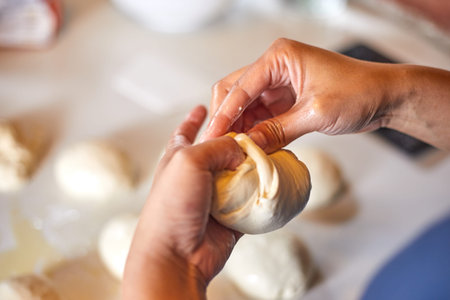 Close up hands preparing dough for pizza