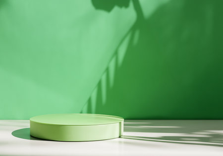 Green round podium in green interior with sunshine and leaf shadows on the wall.の素材