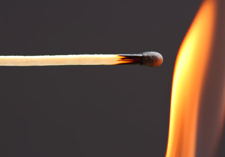 Burning match on a black backgroundの素材