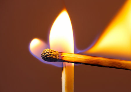 Burning match on a black backgroundの素材