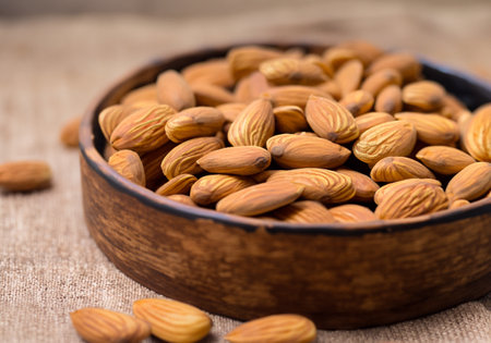 Close up Almonds in bowl , blur backgroundの素材