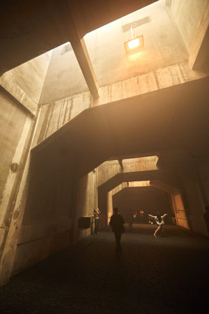 Dark concrete room with warm light, art space