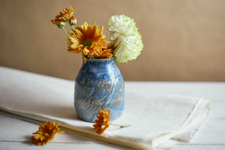 Ceramic vase with flowers on beige background.の写真素材