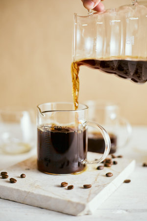 black drip coffee in glass server , selective focus
