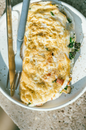 Close up omelet with spinach and hamの写真素材