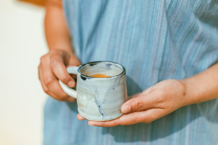A female hand holding a cup of espresso shot.の写真素材