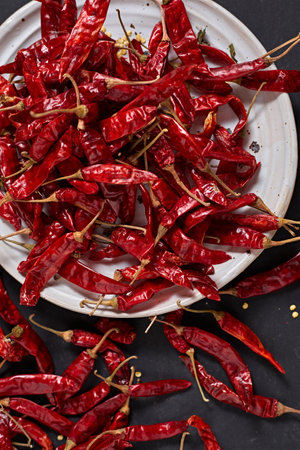 Dried chilli peppers on rustic dark backgroundの写真素材