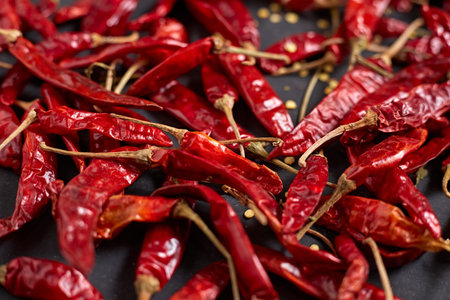 Dried chilli peppers on rustic dark background