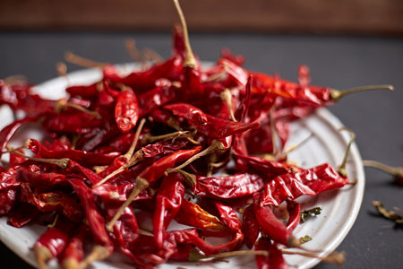 Dried chilli peppers on rustic dark backgroundの写真素材