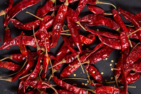 Dried chilli peppers on rustic dark backgroundの写真素材