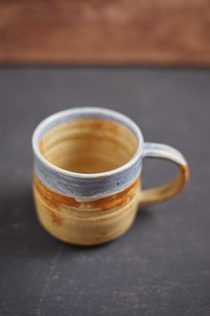 Ceramic cup on rustic background, studio lightの写真素材
