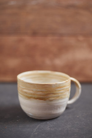Ceramic cup on rustic background, studio lightの写真素材