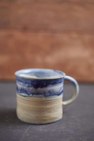 Ceramic cup on rustic background, studio lightの写真素材