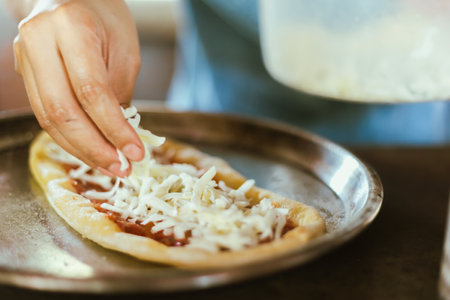 A closeup of hand making an Italian pizzaÂ の写真素材