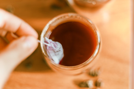 Red tea in the small clear glass on wooden tableの写真素材