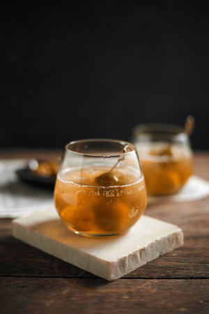 A glass of homemade Umeshu Plum Wine with soda water and iceの写真素材